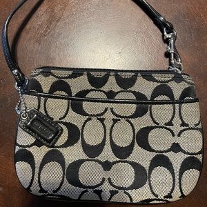 COACH wristlet in their signature print in black & brown.